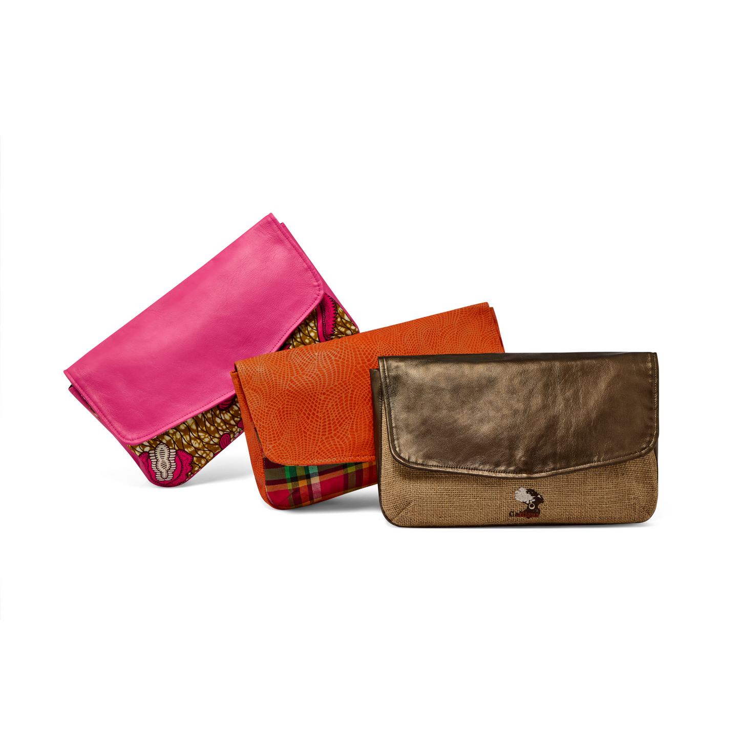 A collection of three Mahalia clutches in pink leather & Pink Paisley African printed fabric, orange leather and Antigua & Barbuda Madras fabric, and Metallic bronze leather with Natural hessian fabric displayed against a white background.