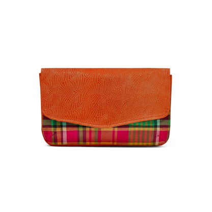 Front head on profile of the Mahalia clutch bag with a Antigua & Barbuda Madras print panel, Papaya Orange textured leather cover,  against a white background.